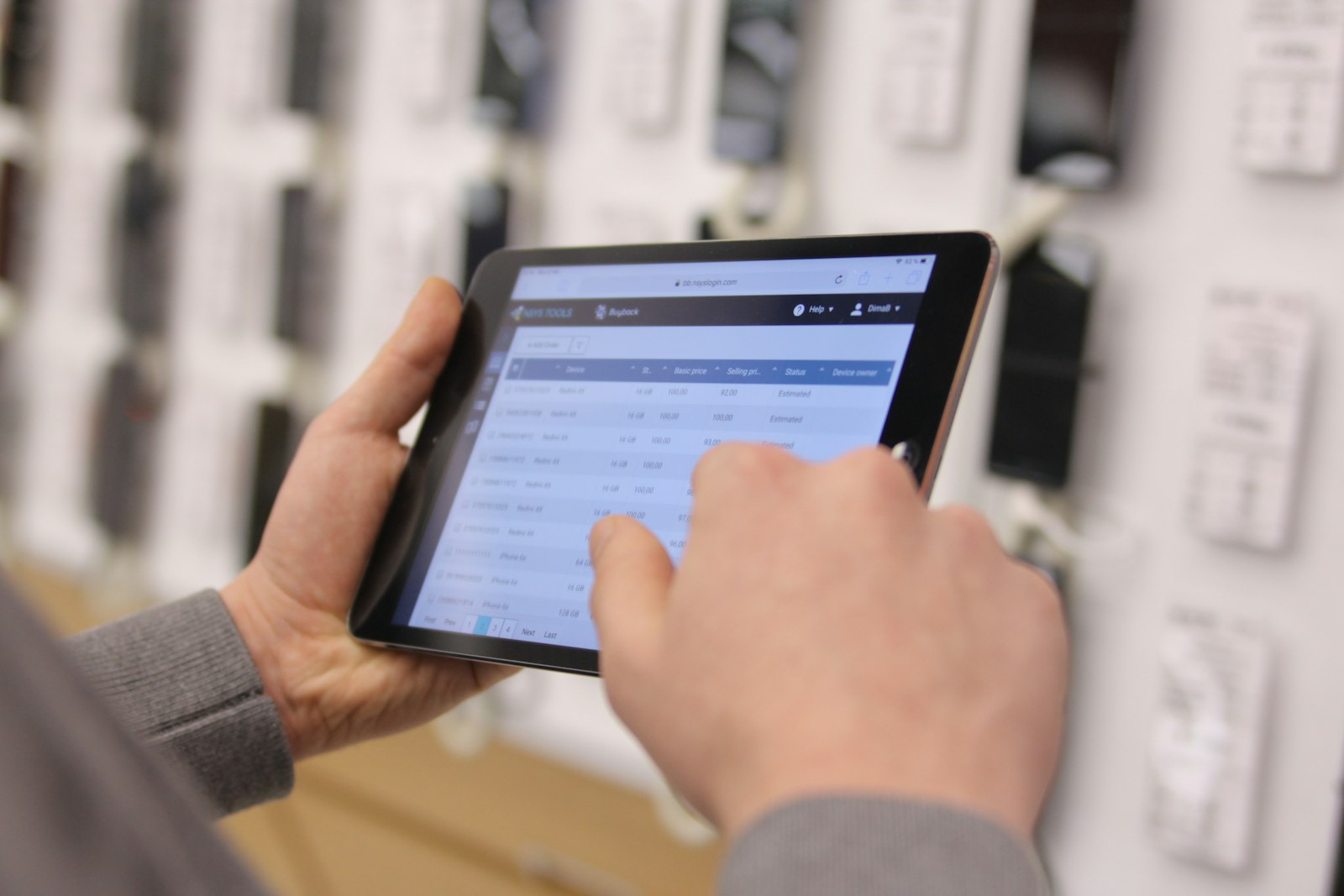 Hands holding a tablet while checking an electrical panel